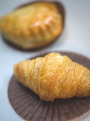 Freshly Croissant in baking paper, Vertical view