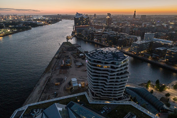 Aerial view of the harbor district, the concert hall "Elbphilharmonie" and downtown Hamburg, Germany, at dusk. Panorama.