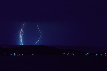 Nature lightning bolt at night thunder storm sea near