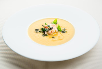 Pumpkin crab soup on a white bowl