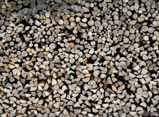 Large stack of cutted trunks and branches. Firewood background and texture. 