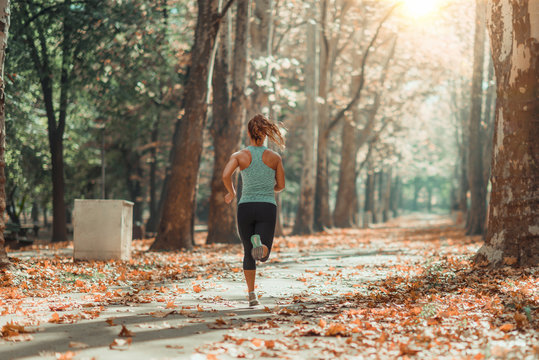 Woman Jogging Outdoors In The Fall