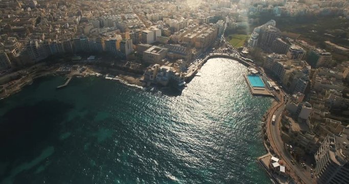 Aerial shot over a city by the shore in Malta Europe
