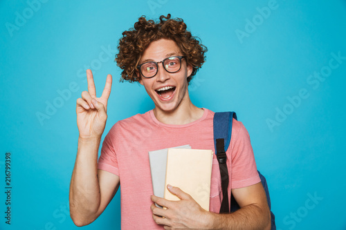 Portrait Of Young Hipster Guy With Curly Hair Wearing