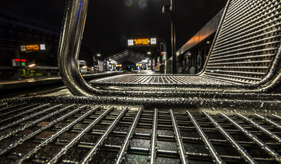 Modern metal seats covered with water drops. Hamburg subway station at rainy day. 