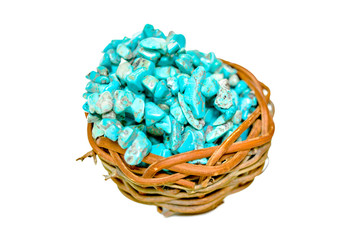 Fototapeta na wymiar Pile stones of raw Turquoise in small wooden nest on a white background
