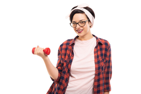 Young pretty pin-up girl holding red dumbbell.