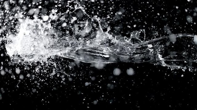 Super slow motion of water splashes on black background. Filmed on high speed cinema camera, 1000 fps.