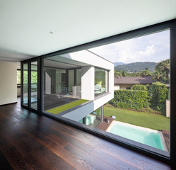 Large window in hallway of modern villa overlooking the private pool - obrazy, fototapety, plakaty