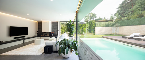 Modern living room overlooking the garden and swimming pool.