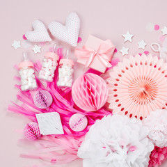 Pink and white Paper Decorations for Baby shower party. It's a Girl. Flat lay, top view