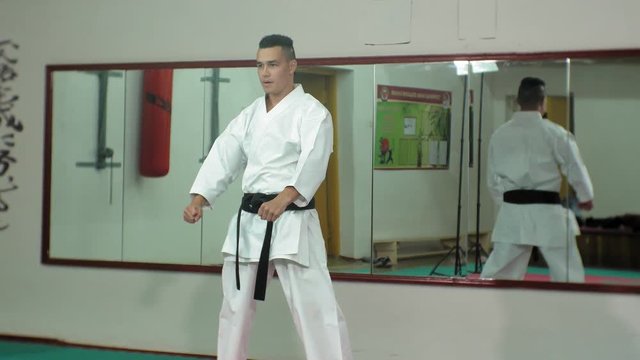 Young man with muscled body, training martial arts Goju-Ryu Karate-Do