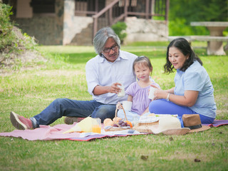 Grandfather spend the time  in holiday with grandchildren at nature park.Happy family concept.