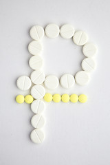 purchase of medicines in Russia: many tablets are laid out on a white background in the form of a ruble sign