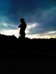 silhouette of a girl against a dark sky