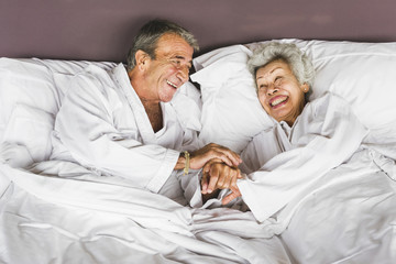 Senior couple lying in bed