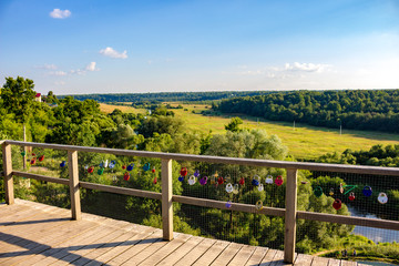 Ermolino, Russia - August 2018: A bunch of wedding locks on the fence of the observation platform in Rusinovo. Kaluzhskiy region, Borovskiy district, Ermolino