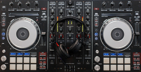 Audio mixing controller with professional headphones. DJ tools. Top view