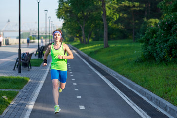 Running Woman on racetrack during training session. Female runner practicing on athletics race track