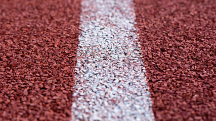 Red treadmill with white line at the stadium