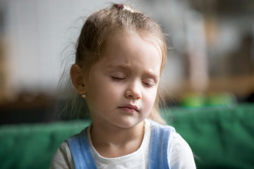 Headshot of upset little girl feeling pain, sad, tired or sleepy, frustrated depressed kid face...