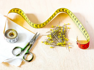 Sewing centimeter, scissors, pins, fabric