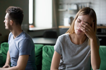 Tired frustrated wife feeling sad after couple fight with stubborn husband, upset millennial woman...