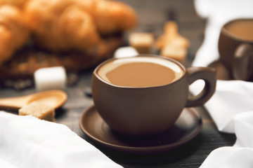 A cup of coffee close-up on a blurred background
