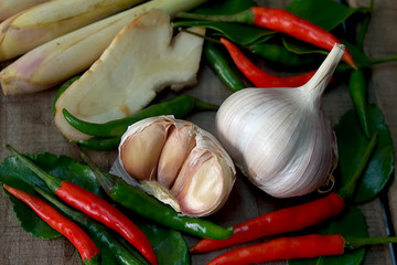  Galangal and lemongrass and chili and garlic and ginger on the wood table in thai kitchen.