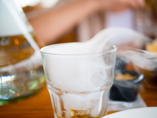 A glass of whiskey with smoke inside.