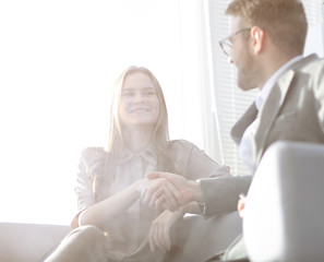 background image of a handshake of colleagues in the workplace