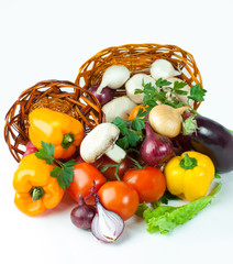 mushrooms and a variety of fresh vegetables in a wicker basket.i