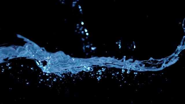 Super slow motion of water waves on black background. Filmed on high speed cinema camera, 1000 fps.