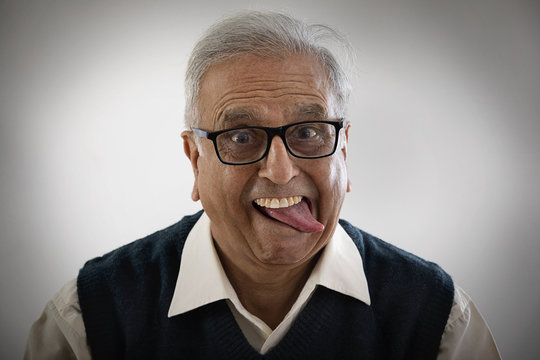 Portrait of an elderly man sticking his tongue out