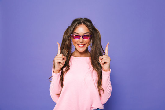 Portrait of a satisfied girl in sweatshirt in sunglasses