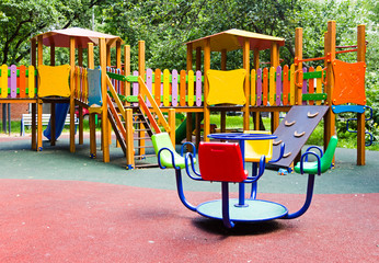 Deserted childern's Playground in city Park in summer.