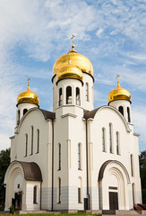 Fototapeta na wymiar Russian white orthodox church against the blue sky.