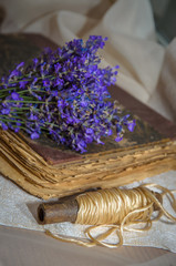 Vintage composition with lavender, old book and rustic twine