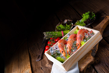 cooked argentine red prawns with salad on the ice