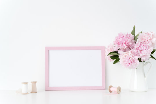 Pink landscape frame mock up with a pink peonies and silk ribbons beside the frame, overlay your quote, promotion, headline, or design, great for small businesses, lifestyle bloggers and social media