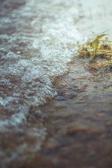 Tiny water wave with bubbles