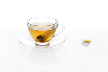 tea bag with glass cup isolated white.
