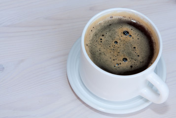 White cup of dark coffee. Delicious black coffee.