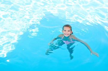 Cute smiling happy little girl child  in swimming pool