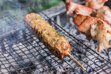Preparation of kebabs on the grill. Fried meat on coals
