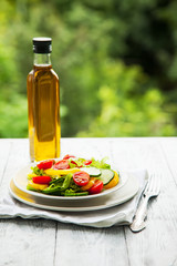 summer vegetable salad with olive oil on wooden backgroun