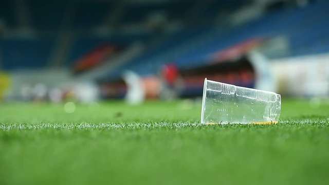 Plastic trash can on the turf on a soccer field