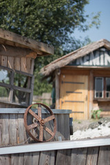 Focus on a steering wheel of a boat next to a house in Rustic village (Prokosovici, Bosnia)