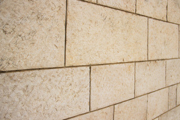 Fototapeta premium Wall of stones of different shapes of light shades
