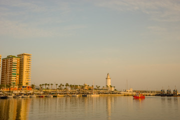 Obraz premium Spain, Malaga, a light house at the quay bay area